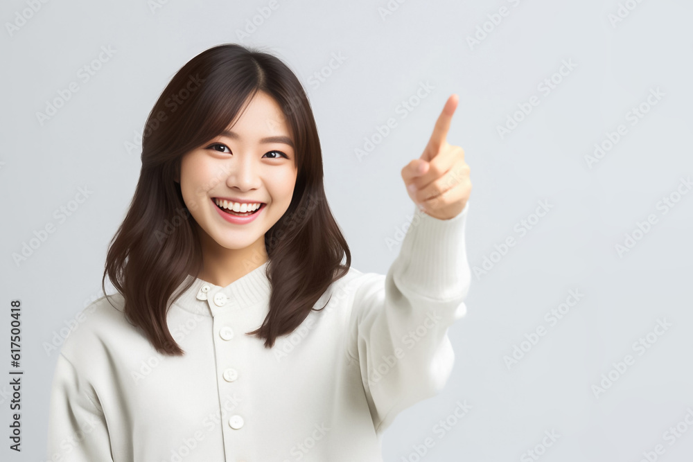 Pointing finger of an Asian girl highlights vacant space on a white background, making it a prime choice for a promotional advertising banner. Generative AI. Pointing finger of an Asian girl highlights vacant space on a white background, making it a prime choice for a promotional advertising banner. Generative AI.