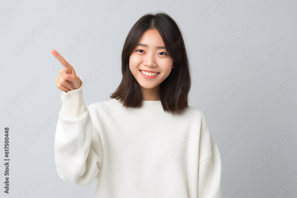 Pointing finger of an Asian girl highlights vacant space on a white background, making it a prime choice for a promotional advertising banner. Generative AI. Pointing finger of an Asian girl highlights vacant space on a white background, making it a prime choice for a promotional advertising banner. Generative AI.