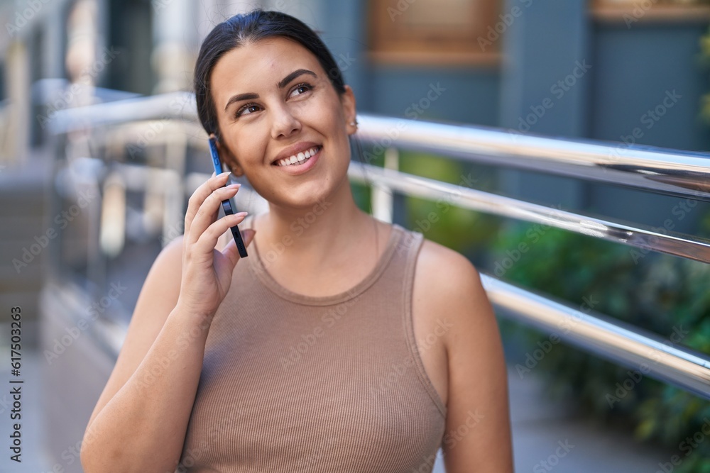 Young beautiful hispanic woman smiling confident talking on the smartphone at street Young beautiful hispanic woman smiling confident talking on the smartphone at street