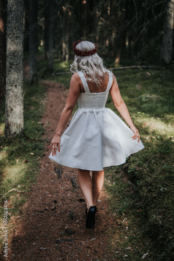 Happy Woman Walking in Green Forest, Wearing Fashionable Dress