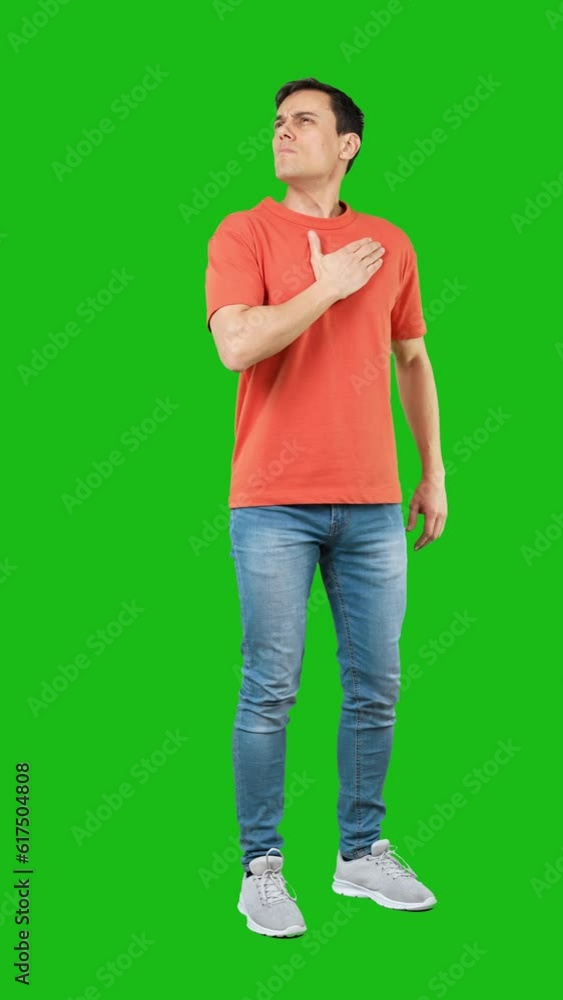 Serious man with hand on chest. Green background Serious man with hand on chest. Green background