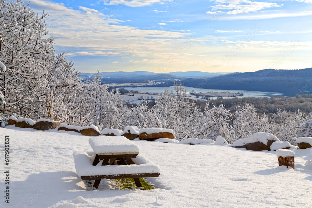 Sunrise on a snow covered mountain with a picnic table in the foreground. Lancaster County, Pennsylvania, USA. Sunrise on a snow covered mountain with a picnic table in the foreground. Lancaster County, Pennsylvania, USA.