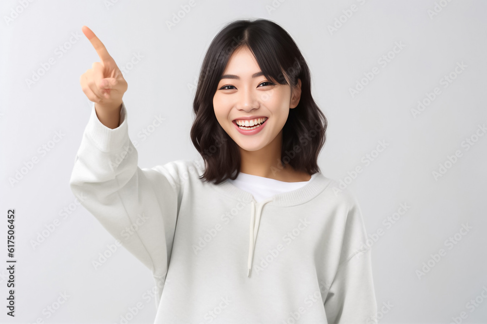 Pointing finger of an Asian girl highlights vacant space on a white background, making it a prime choice for a promotional advertising banner. Generative AI. Pointing finger of an Asian girl highlights vacant space on a white background, making it a prime choice for a promotional advertising banner. Generative AI.