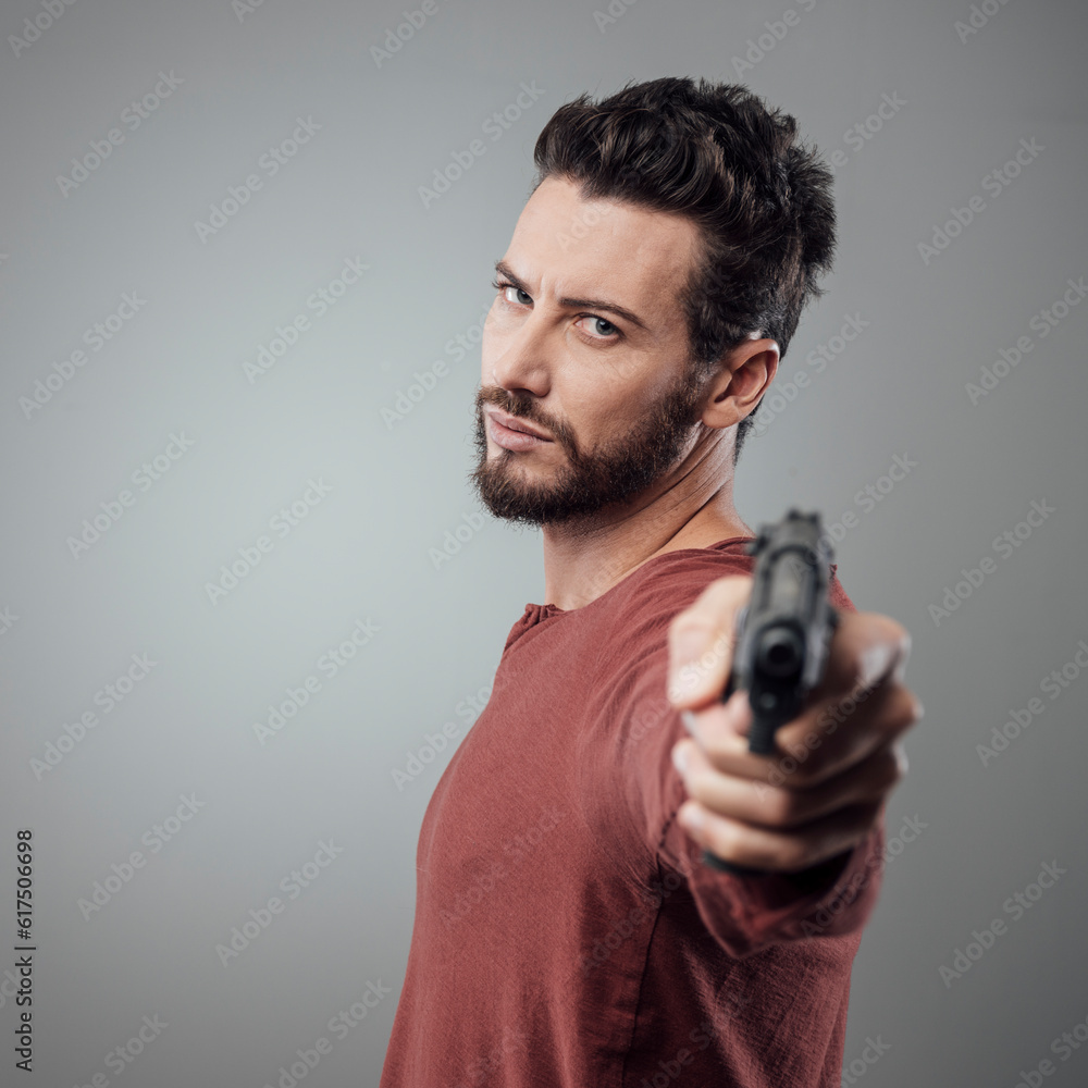 Confident aggressive man holding a gun, cool attitude Confident aggressive man holding a gun, cool attitude