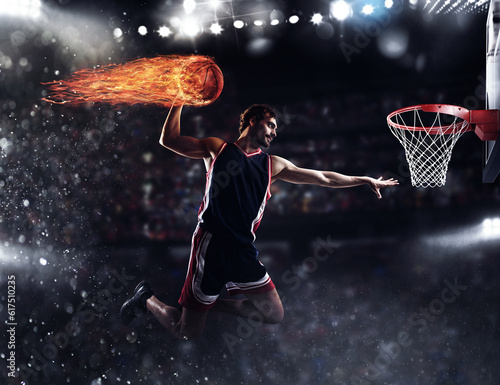 Player throws the fireball in the basket in the stadium full of spectators © Designpics