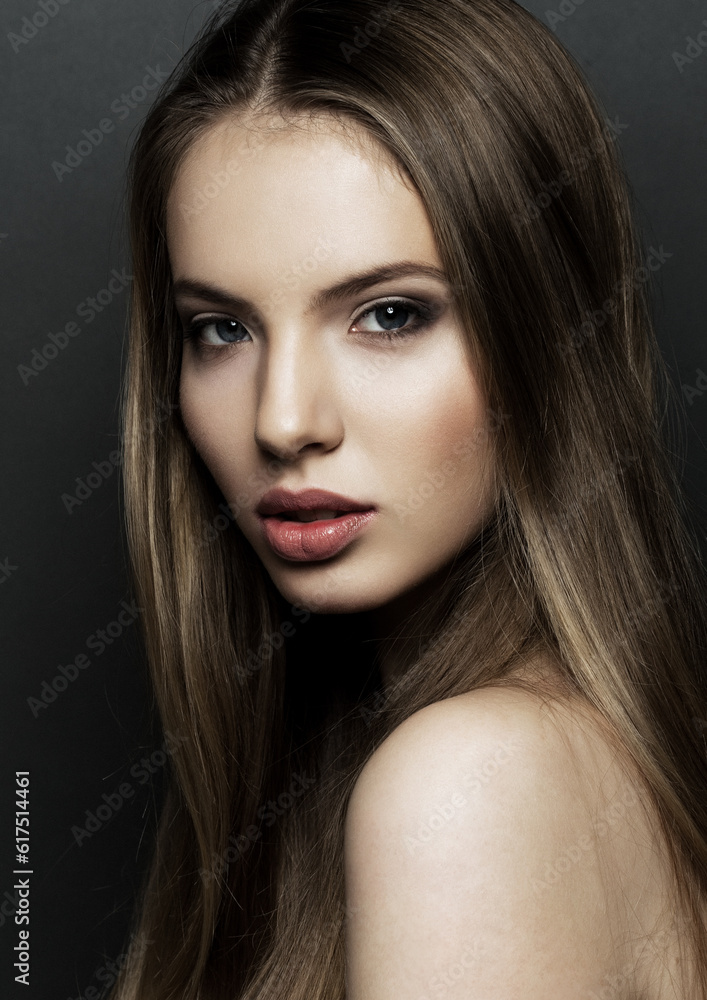 Fototapeta premium Beautiful woman model portrait with long hair on black background. Red lips