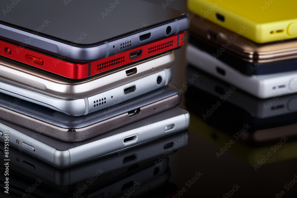 Mobile phone wireless communication technology and mobility business office concept - group of smartphones on black background