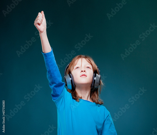 Boy with Blond Hair Listening to Music in Headphones photo