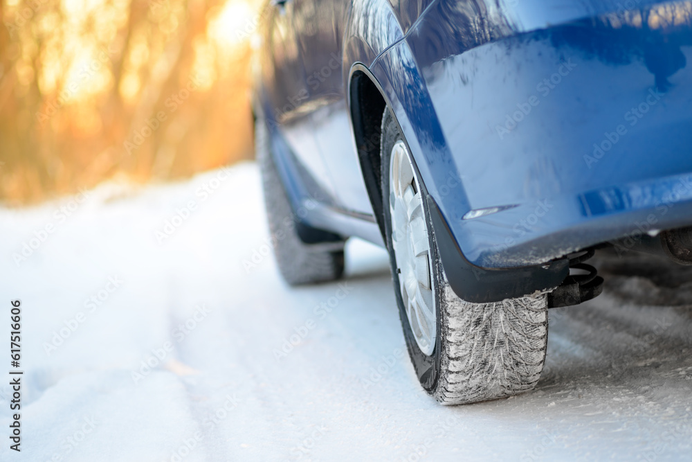 Close-up Image of Winter Car Wheel on the Snowy Road. Drive Safe Concept.