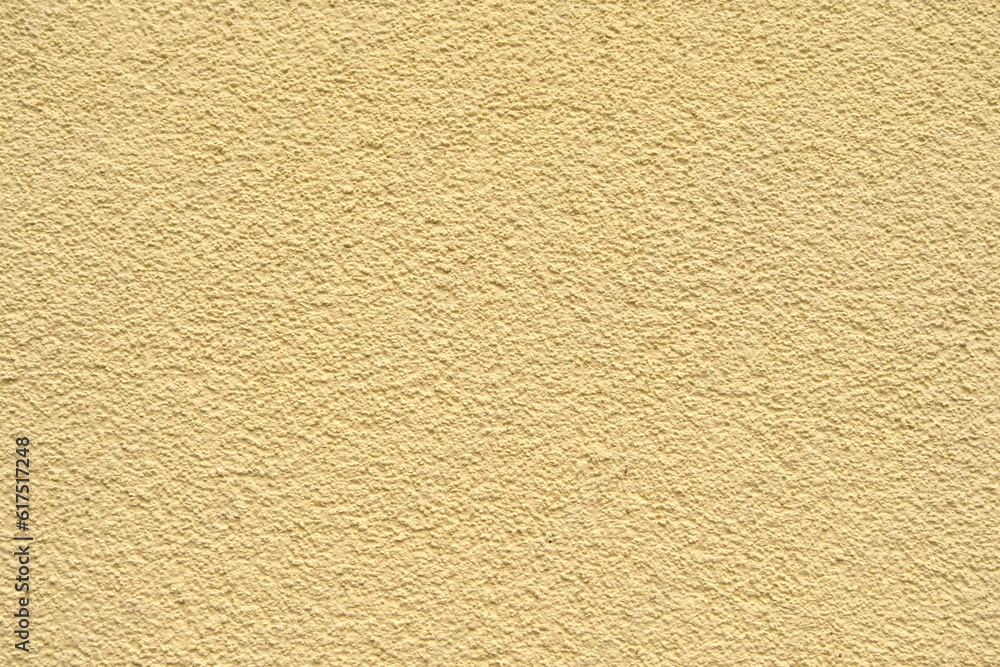 the wall is decorated with yellow plaster the wall is decorated with yellow plaster