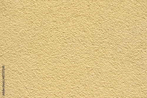 the wall is decorated with yellow plaster