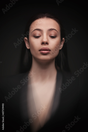 portrait young elegant woman with closed eyes wearind black jacket. Fashion studio shot. Motion effect