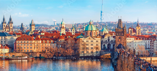 Old town of Prague, Czech Republic over river Vltava with cathedral and Charles bridge on skyline. Bright sunny day with blue sky. Praha panorama landscape view.