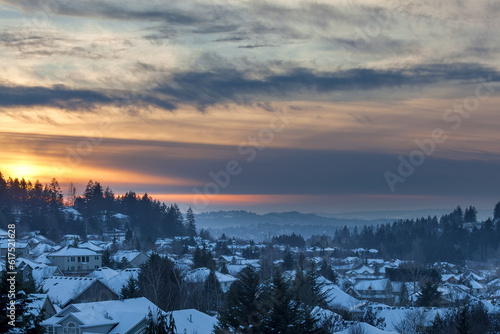 Happy Valley Oregon suburban neighborhood homes covered in snow during sunset