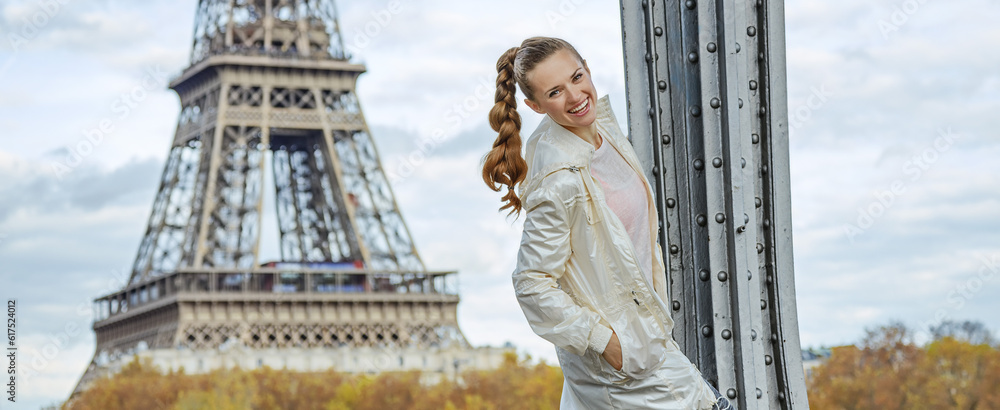 Year round fit & hip in Paris. Portrait of happy young fitness woman against Eiffel tower in Paris