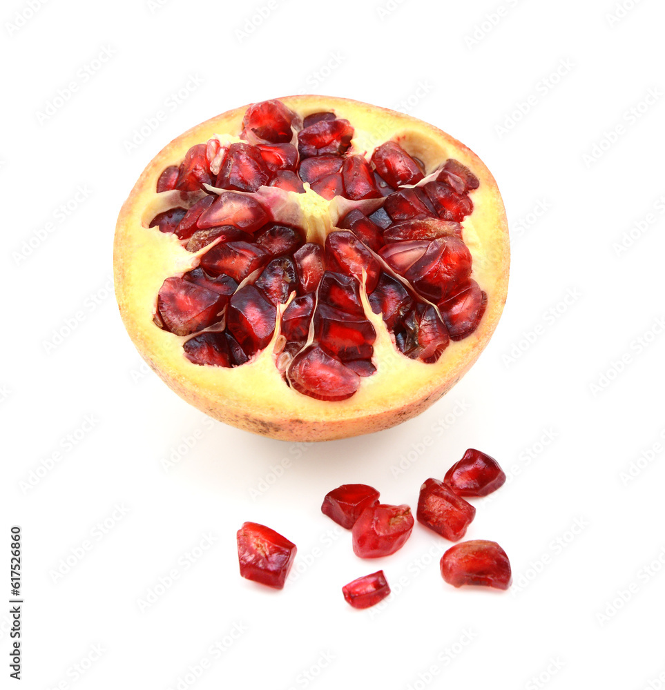 Cut half pomegranate cross section with seeds removed and spilled on white background Cut half pomegranate cross section with seeds removed and spilled on white background