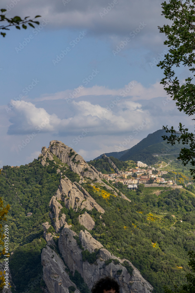 Fototapeta premium View of Pietrapertosa and Castelmezzano. Two beautiful villages built on the Lucanian Dolomites in Italy. Connected by a zipline that crosses the valley adrenaline-pumping experience. Day and sunset.