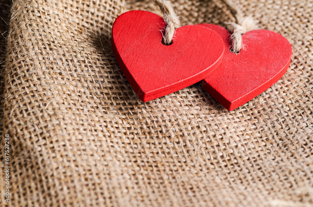 Obraz premium Couple of decorative wooden red hearts for Valentine's day on canvas background