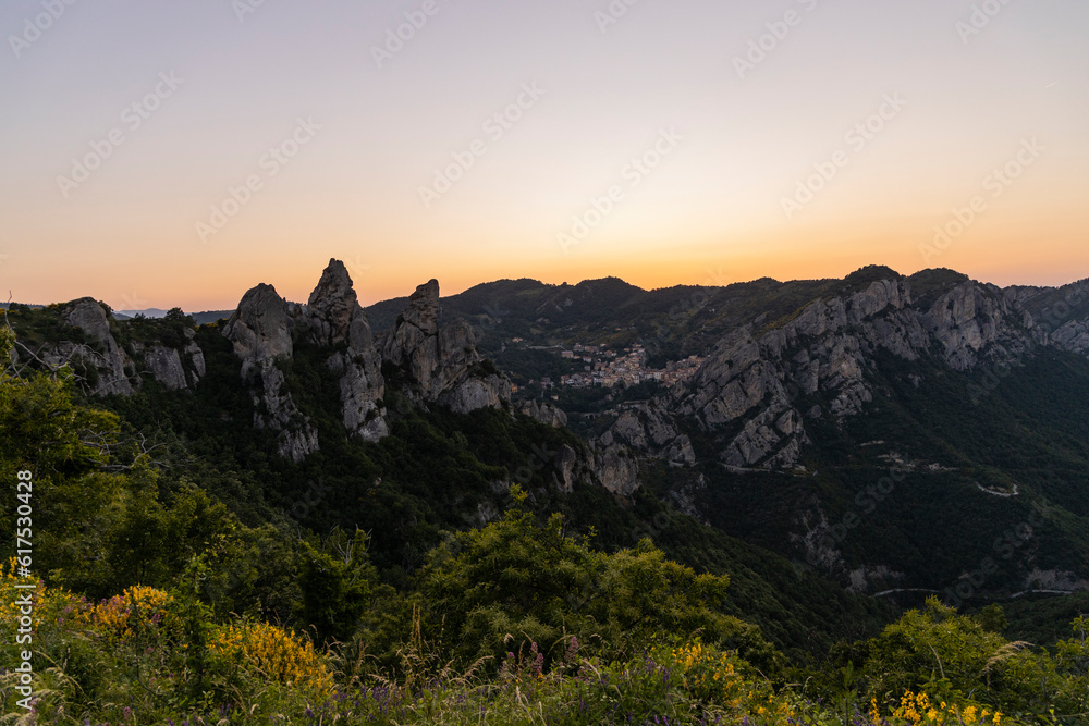 View of Pietrapertosa and Castelmezzano. Two beautiful villages built on the Lucanian Dolomites in Italy. Connected by a zipline that crosses the valley adrenaline-pumping experience. Day and sunset. View of Pietrapertosa and Castelmezzano. Two beautiful villages built on the Lucanian Dolomites in Italy. Connected by a zipline that crosses the valley adrenaline-pumping experience. Day and sunset.