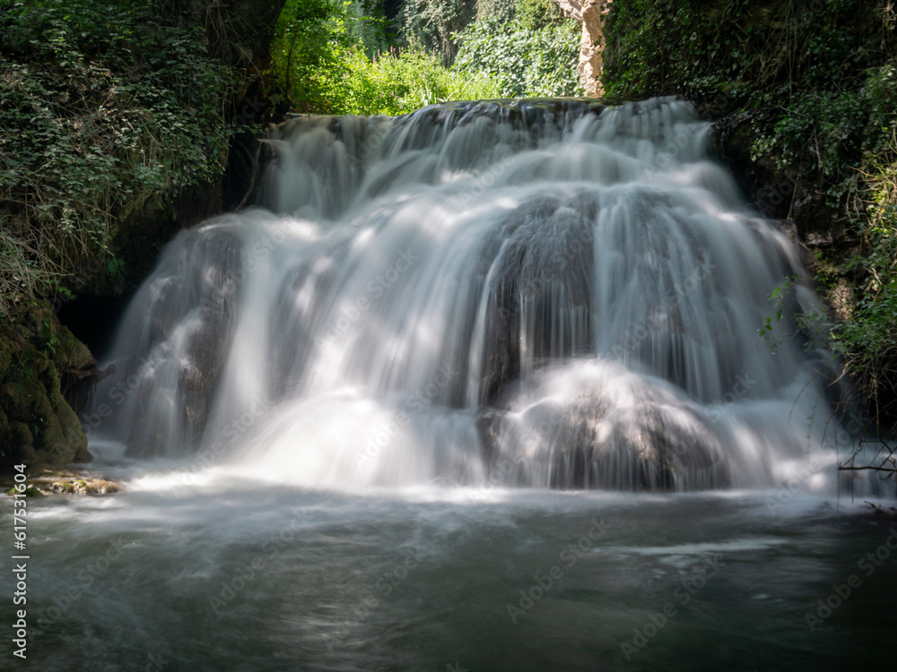Fototapeta premium Stone monastery garden park with lush waterfalls