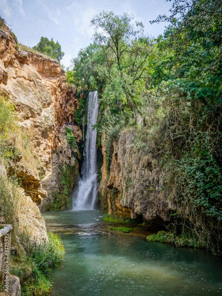 Stone monastery garden park with lush waterfalls Stone monastery garden park with lush waterfalls