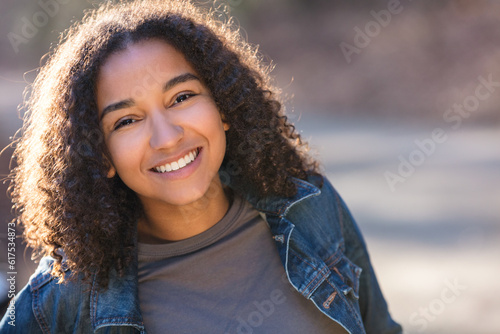 Fotografie Outdoor portrait of beautiful happy mixed race African American girl teenager fe