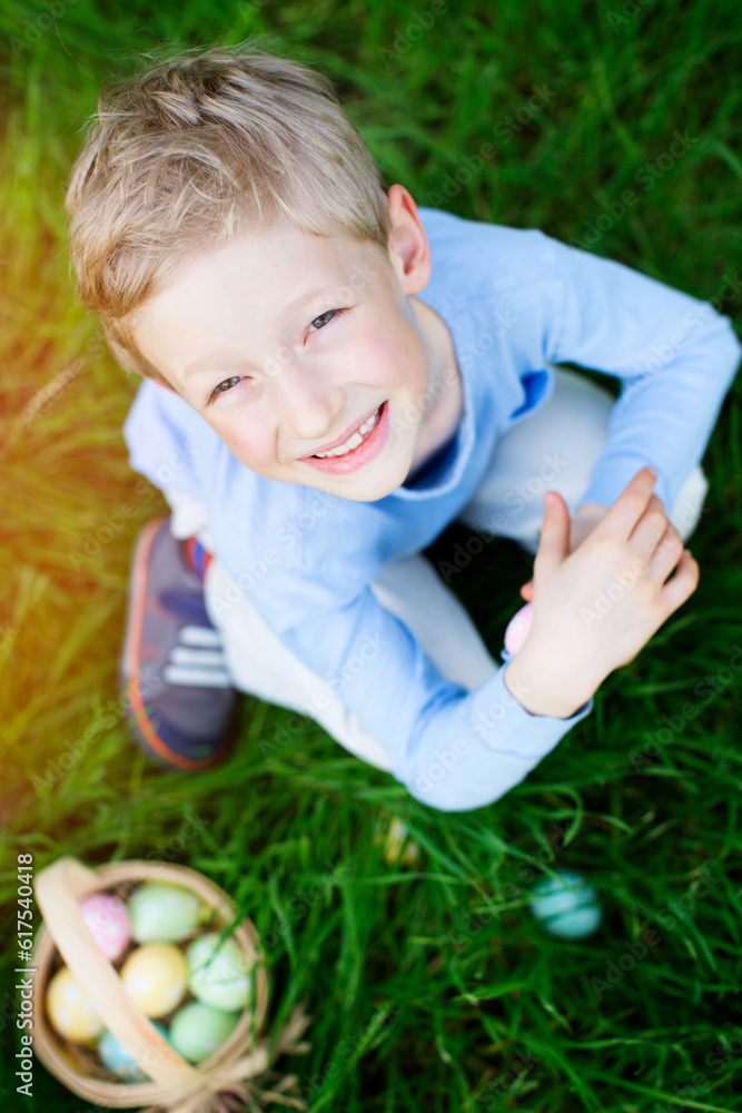 cheerful little boy enjoying easter egg hunt at spring cheerful little boy enjoying easter egg hunt at spring