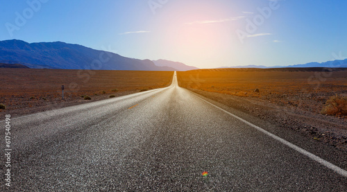 empty beautiful road in death valley national parl, california, sun flare, travel concept