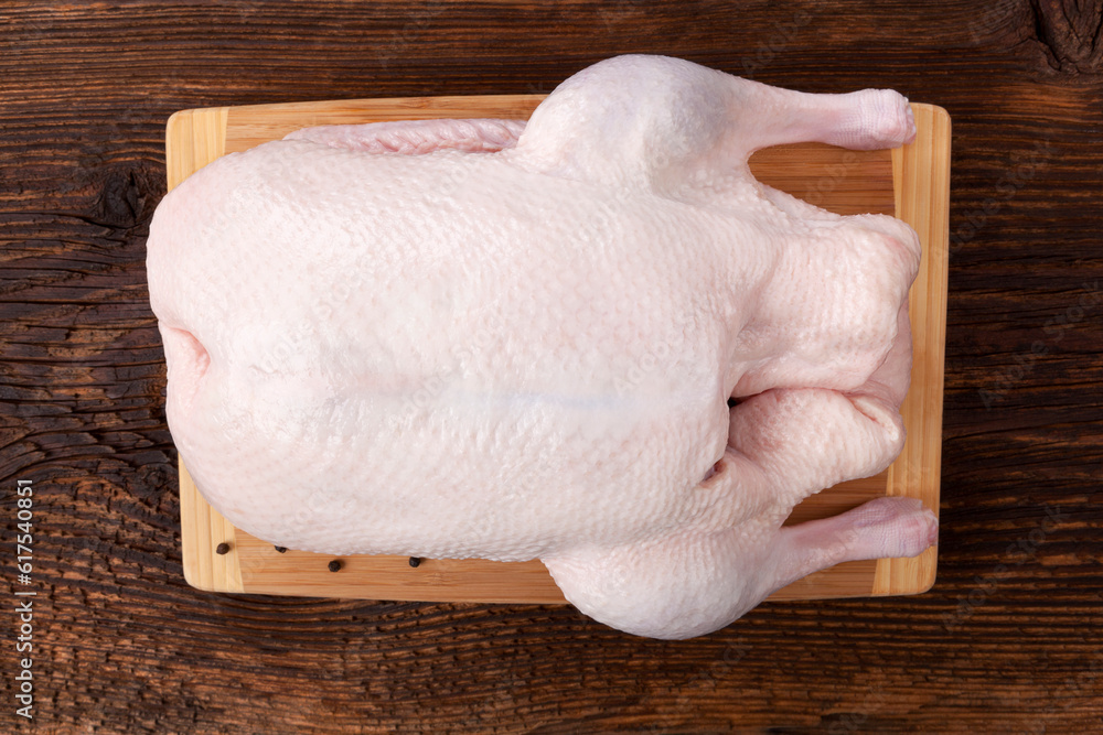 Fresh raw duck isolated on wooden rustic table, flat lay. Culinary cooking. Fresh raw duck isolated on wooden rustic table, flat lay. Culinary cooking.