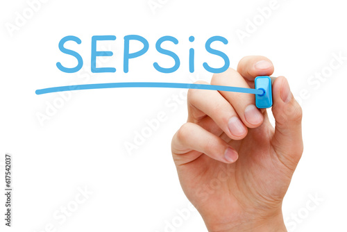 Hand writing Sepsis with blue marker on transparent glass board.