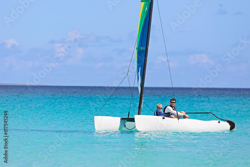 family of two, father and son, enjoying sailing together at hobie cat catamaran, active healthy lifestyle photo