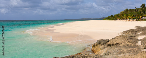 panorama of rocky rugged shore with white sand beach and turquoise lagoon at anguilla island