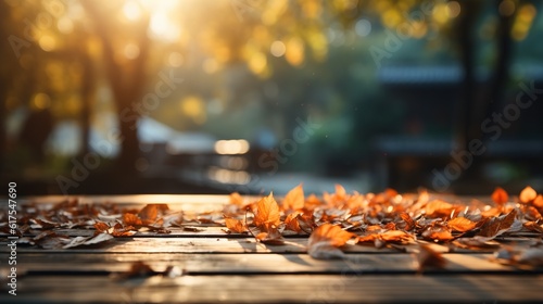 Empty wooden table top with autumn leaves  blurry background  product presentation concept