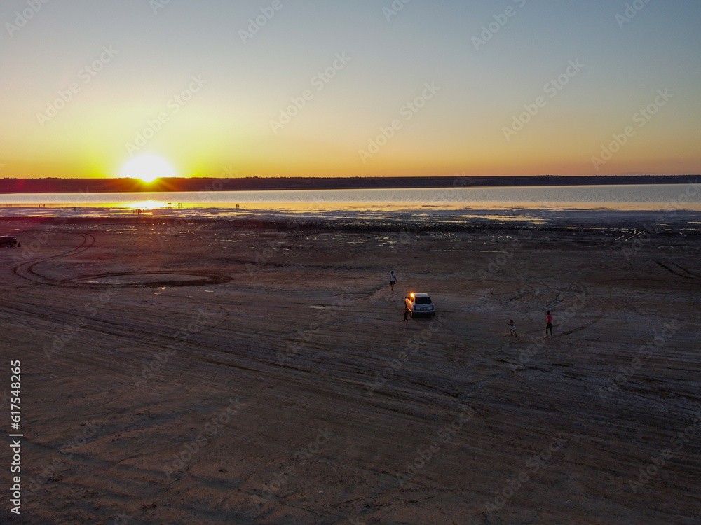 Obraz premium breathtaking sunset over a salt lake, with hues of orange and pink colors