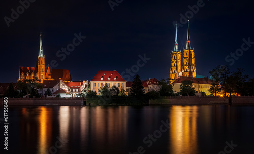 Illuminated Ostrow Tumski in Wroclaw in Poland with reflection in Odra river