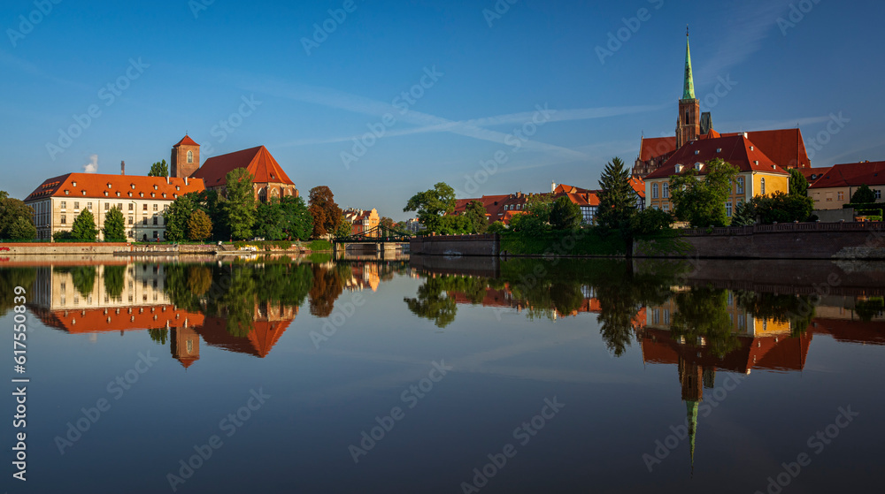 Beautiful old Ostrow Tumski and library and church on Sand Island in Wroclaw in Poland with reflection in Odra river