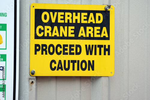 Overhead crane caution sign at factory.
