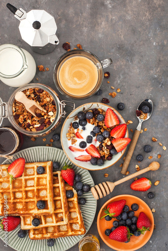 Healthy breakfast table with cereal granola, milk, fresh berries, coffee and waffles, top view © Designpics