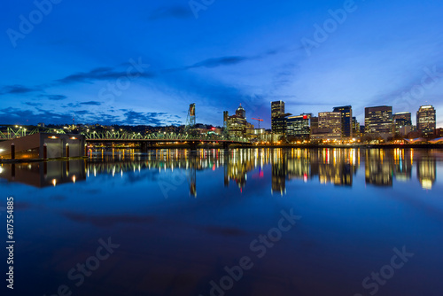 Portland Oregon downtown city skyline by Hawthorne Bridge over Willamette River waterfront during evening blue hour