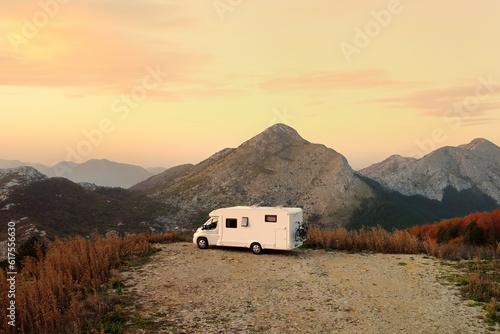 Drone aerial view of parked big modern camper motorhome. Family vacation travel RV. Bicycles attached to a caravan. Travel and adventure. Go everywhere