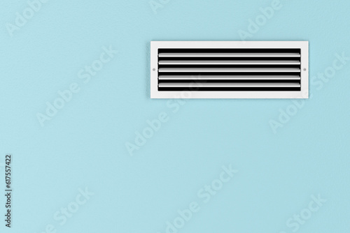 Air conditioning vent on the blue wall photo