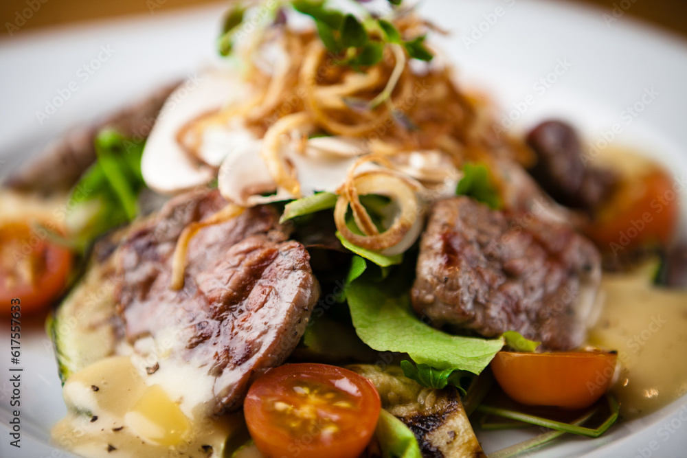 Brutus salad with beef tenderloin served on a plate Brutus salad with beef tenderloin served on a plate