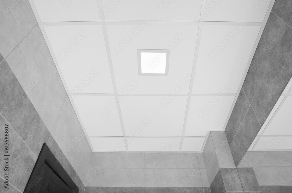 Fototapeta premium White ceiling with modern lighting in room, low angle view