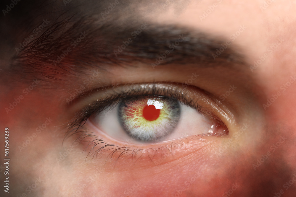 Obraz premium Paranormality, supernatural or mental disorders concepts. Man with eye lighting up from inside, closeup
