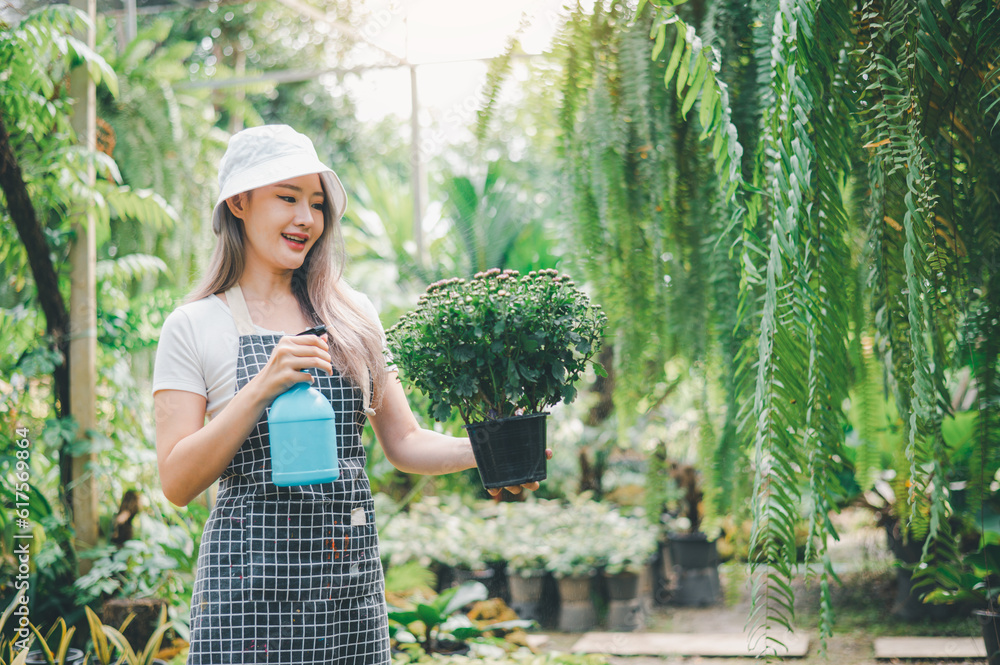 Obraz premium Young women doing hobbies taking care of plants, watering, shoveling flowers. In the garden during the break from work