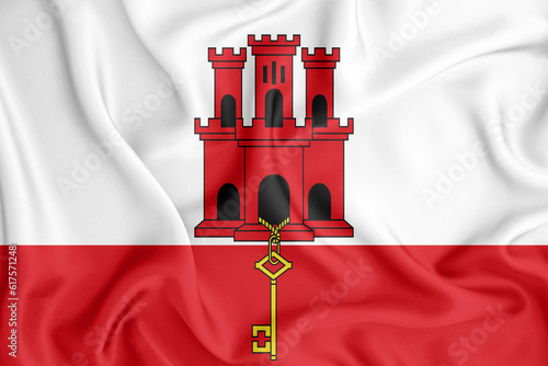 Gibraltar flag waving with the wind, wide format, 3D illustration rendring. Design with satin fabric. to be used for educational purposes or for illustrations of videos or vlogs.