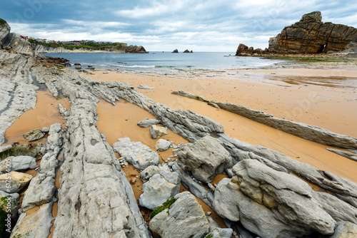 Detail of bare rocks because of low tide at cbeach (Pielagos, Cantabria) photo