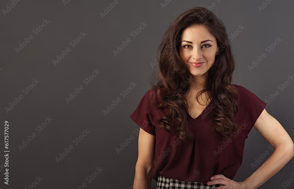 Beautiful natural makeup smiling woman with long curly volume brown healthy hair style looking happy. Closeup portrait on grey background. Beautiful natural makeup smiling woman with long curly volume brown healthy hair style looking happy. Closeup portrait on grey background.
