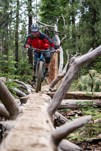 mountain biking in bend oregon and riding a downed tree photo