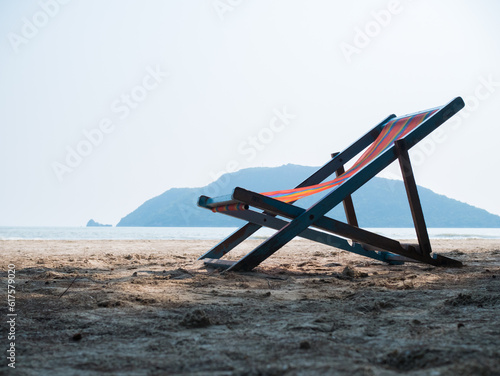 Deck chair on sandy beach during day